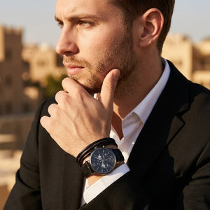 Elegant dynamic man wearing Tommy Hilfiger Evan Chronograph 1710395 sports watch with integrated flexible rich black leather strap adding distinctive bold dynamic masculine casually luxurious style visual flow central Analogue central central Analogue Central central central Analogue Central