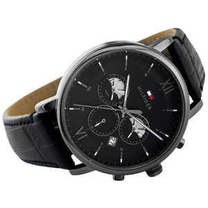 Angled profile left view of Tommy Hilfiger Evan Men's 1710395 watch highlighting dynamic flexible integrated rich black genuine leather genuine leather strap structure dynamic contrasting white stitch details polished stainless steel buckle clasp central Analogue central minute track dynamic casually luxurious style visual casual dynamic visual casual utility