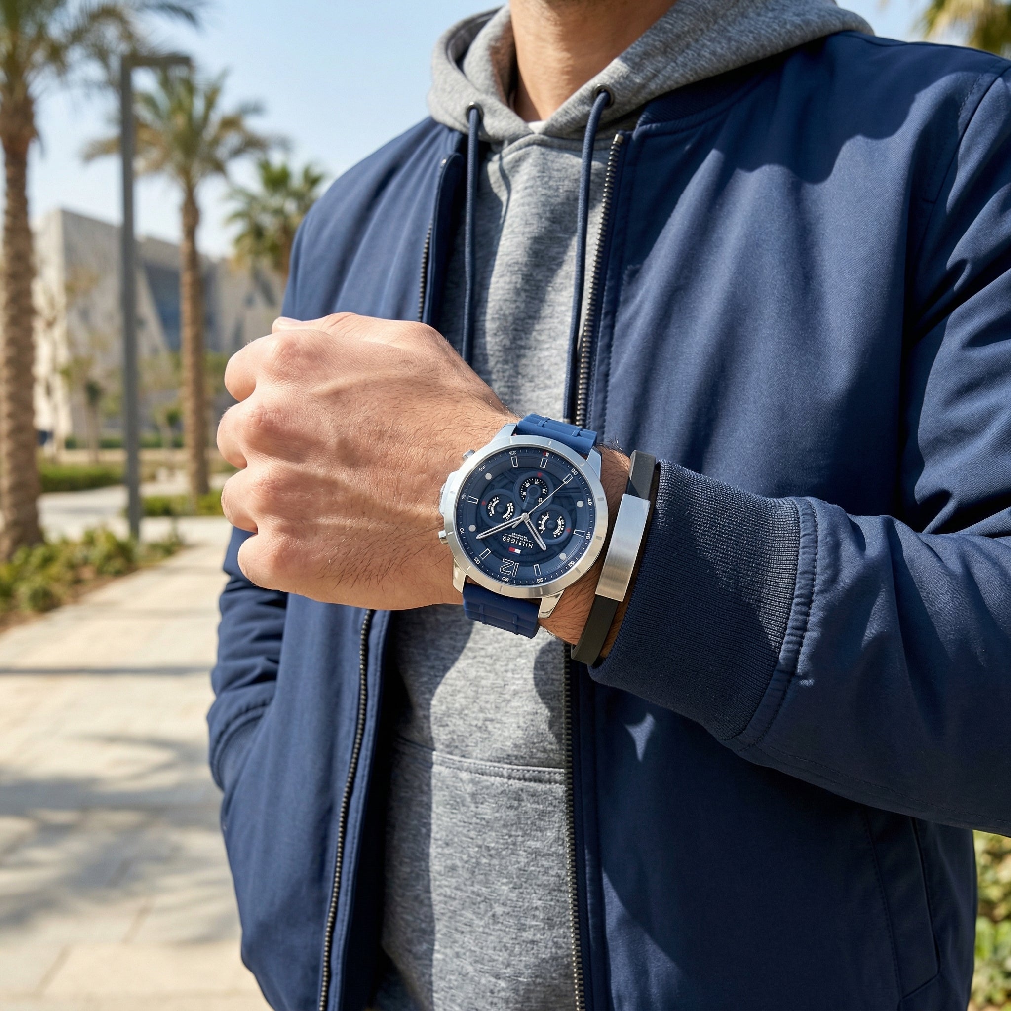 Lifestyle photo of Tommy Hilfiger 1710489 showing the watch on a man's wrist with sporty blue strap