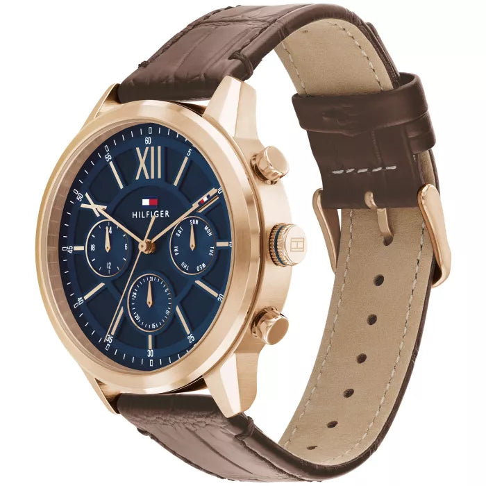 Left angled view of Tommy Hilfiger Morrison 1710526 men's quartz battery watch showing brown leather strap and gold-tone case profile