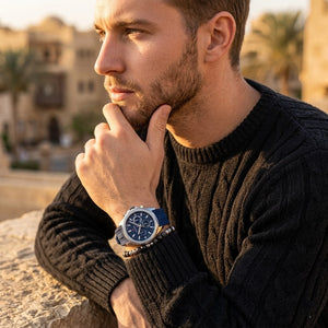 Elegant man wearing Tommy Hilfiger Lars 1710649 men's quartz battery watch with silver case and luxury racing blue rubber strap