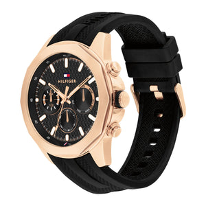 Left angled view of Tommy Hilfiger Lars  1710650 men's quartz battery watch showing black rubber strap and rose gold-tone case profile