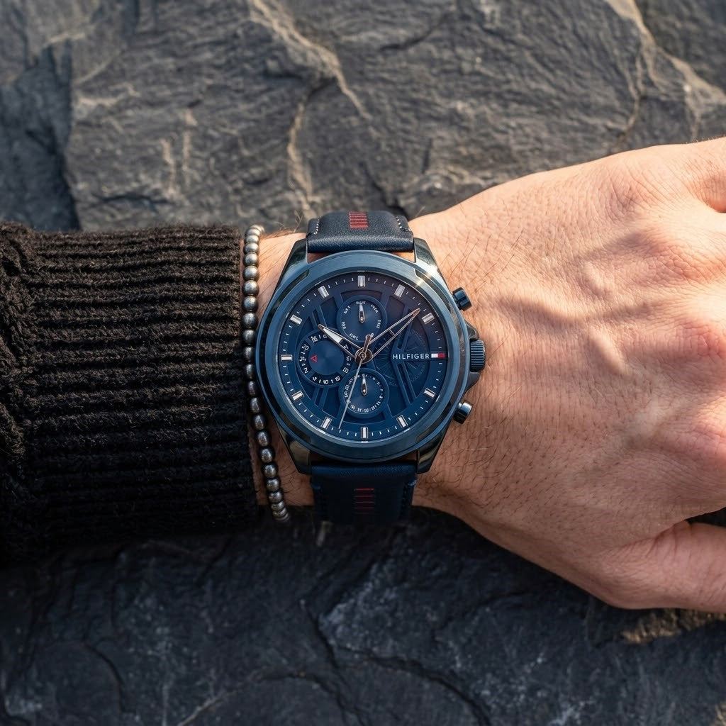 Close up of Tommy Hilfiger Jax 1710655 men's quartz battery watch on wrist showing navy blue technical dial and red strap accents