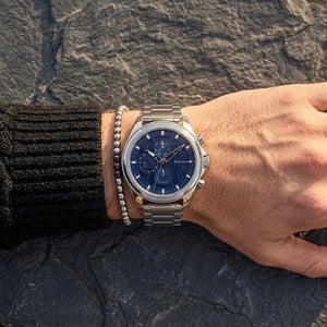 Close up of Tommy Hilfiger Jax 1710656 men's quartz battery watch on wrist showing navy blue technical dial and silver link bracelet