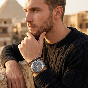 Elegant man wearing Tommy Hilfiger Henry 1710683 men's quartz battery watch with silver case and luxury grey skeleton dial