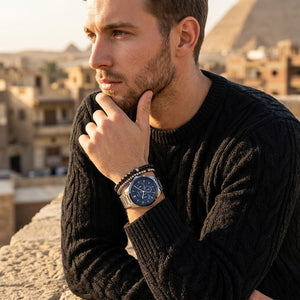 Elegant man wearing Tommy Hilfiger Henry 1710684 men's quartz battery watch with silver case and luxury skeleton blue dial