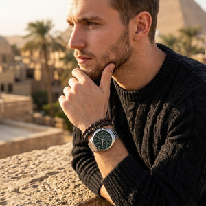 Elegant man wearing Tommy Hilfiger Henry 1710686 men's quartz battery watch with silver case and luxury skeleton green dial
