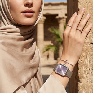 Elegant woman wearing Tommy Hilfiger Tea 1782790 women's quartz battery watch with silver case and luxury square mesh strap