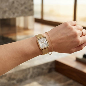 Close up of Tommy Hilfiger Tea 1782829 women's quartz battery watch on wrist showing square silver dial and luxury crystal bezel