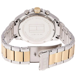 Close-up of a Tommy Hilfiger watch with two-tone metal band on a white background