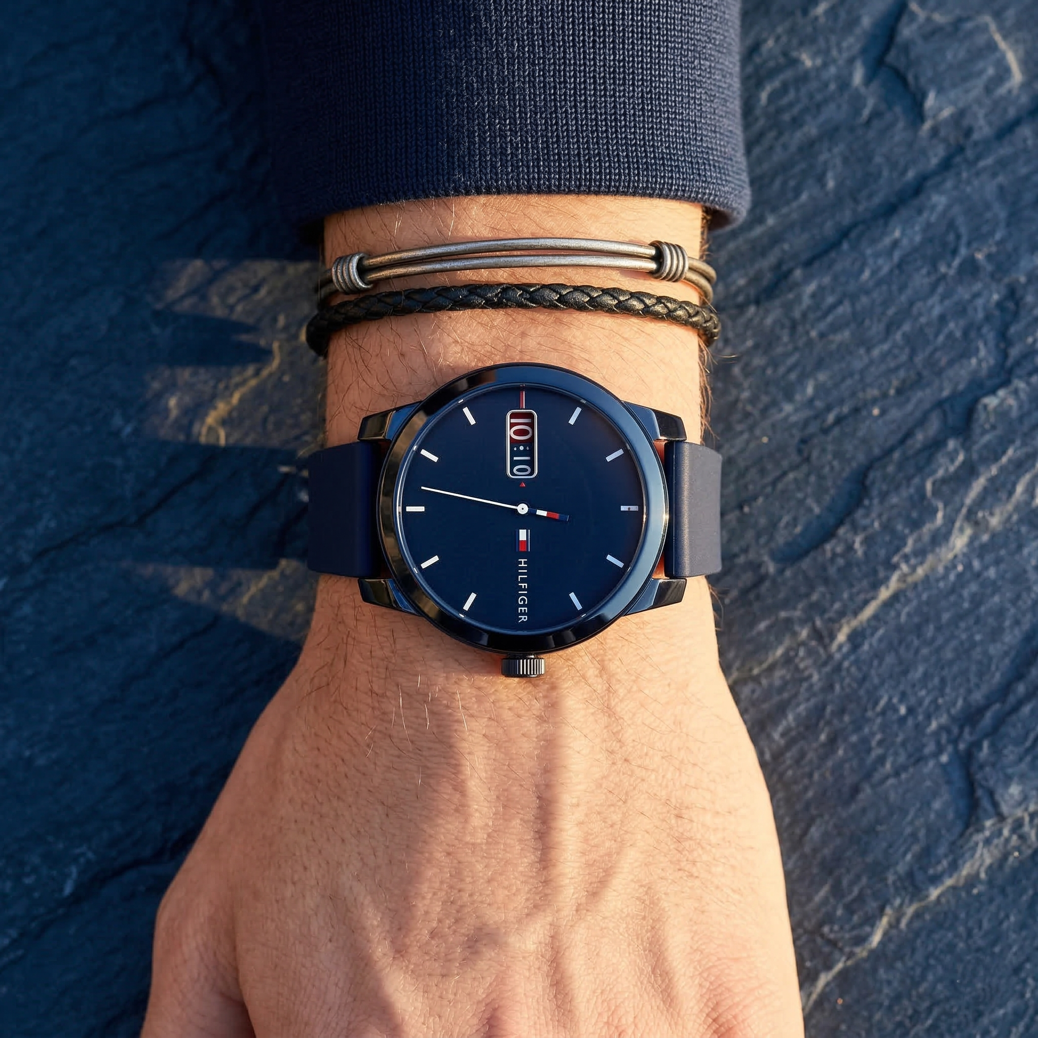 Close up of Tommy Hilfiger Denim 1791381 men's quartz battery watch on wrist showing blue sunray dial and blue rubber strap
