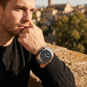 Elegant man wearing Tommy Hilfiger Gavin 1791469 men's quartz battery watch with silver-tone case and luxury metal strap