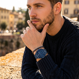 Elegant man wearing Tommy Hilfiger Gavin 1791471 men's quartz battery watch with blue-tone case and luxury mesh strap
