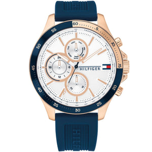 Tommy Hilfiger Bank 1791778 men's watch featuring a gold-tone case, white multi-function dial, blue bezel, and blue rubber strap