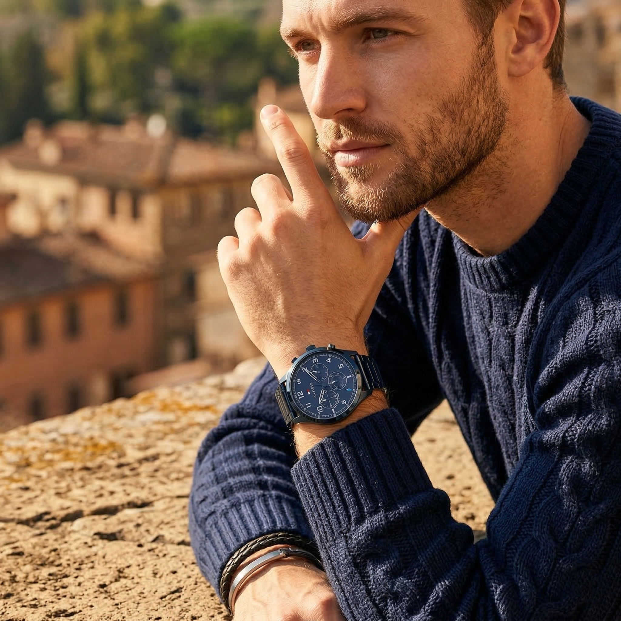Elegant man wearing Tommy Hilfiger Asher 1791853 men's quartz battery watch with blue-tone case and luxury logo dial
