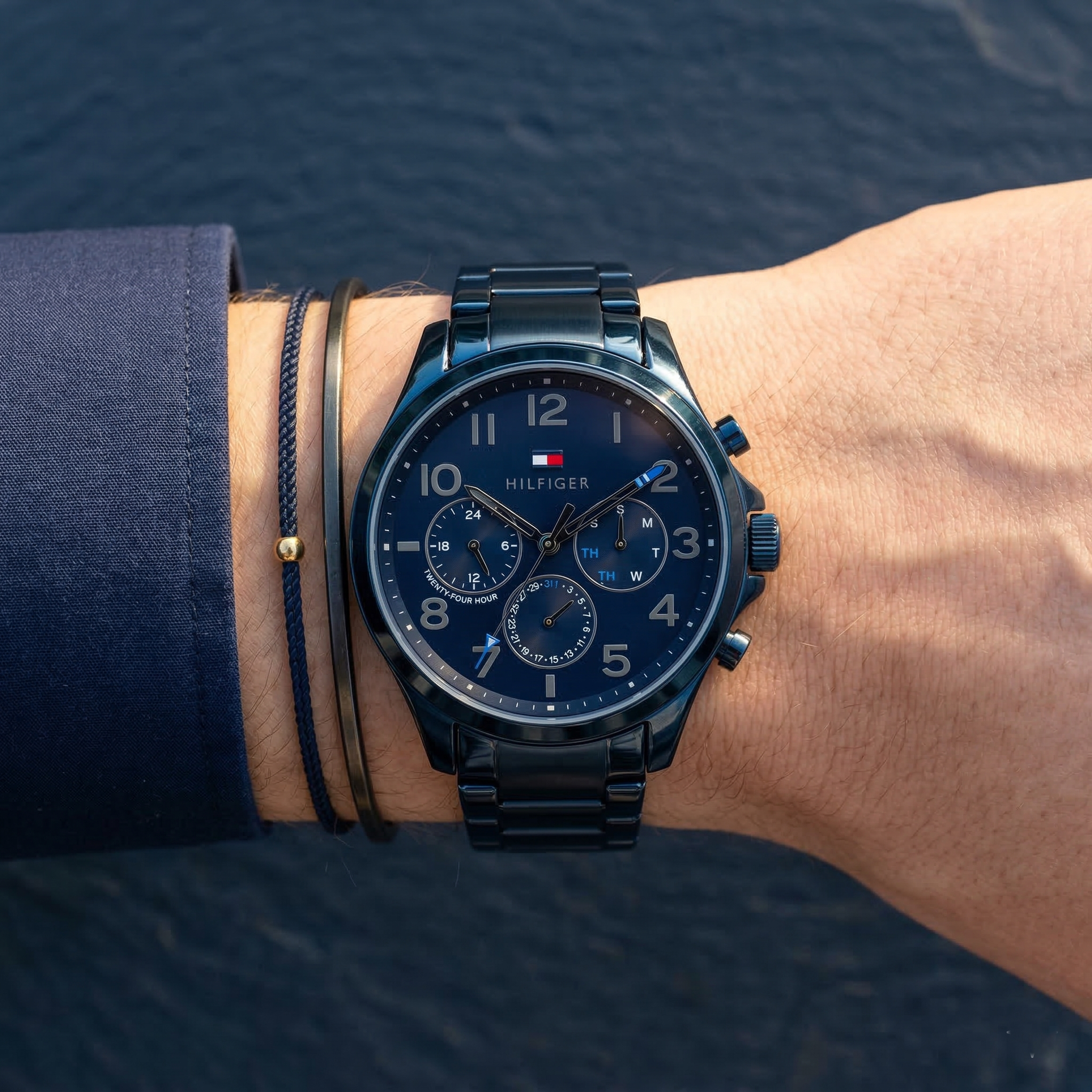Close up of Tommy Hilfiger Asher 1791853 men's quartz battery watch on wrist showing blue multi-function dial and blue metal bracelet