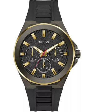 A Guess men's analog watch with a black textured dial, gold-tone indices and hands, and a black silicone strap, shown on a plain white background.