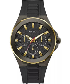 A Guess men's analog watch with a black textured dial, gold-tone indices and hands, and a black silicone strap, shown on a plain white background.