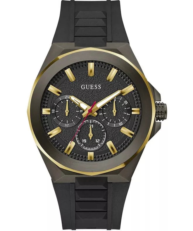 A Guess men's analog watch with a black textured dial, gold-tone indices and hands, and a black silicone strap, shown on a plain white background.