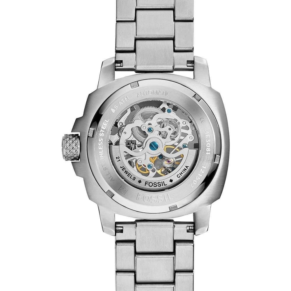 Silver Fossil watch with mechanical movement on a white background