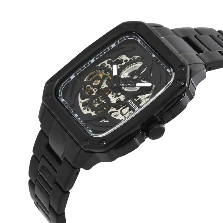 A black skeleton watch with a rectangular case and matching black link bracelet, shown on a plain white background. The watch face is partially transparent, revealing the inner mechanical gears and movement.