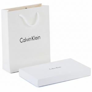 Calvin Klein branded white box and shopping bag on a white background
