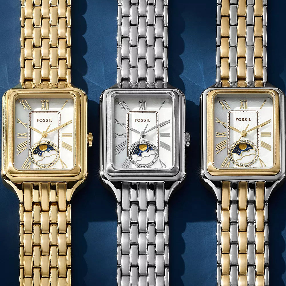 Three Fossil watches with different colored metal bands on a blue background