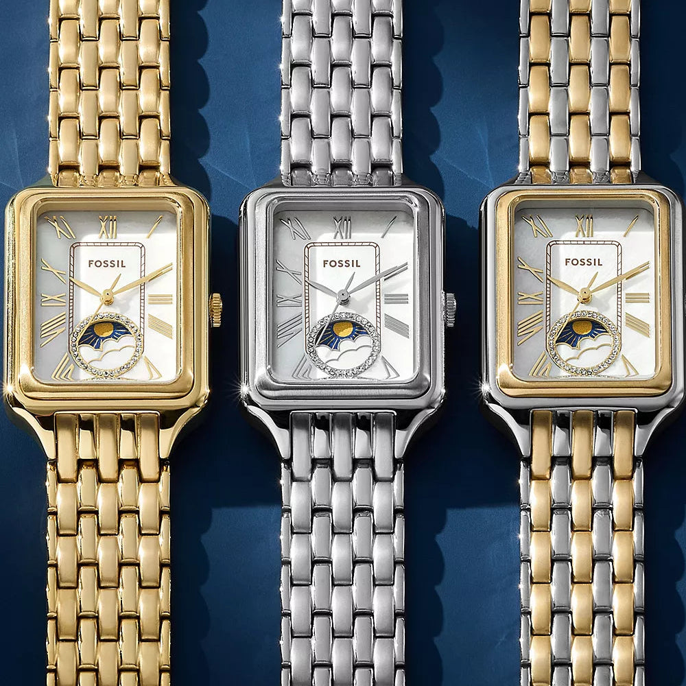 Three Fossil watches with different colored metal bands on a blue background