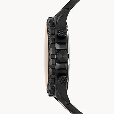 A close-up side profile of a rugged black smartwatch with a textured bezel and matching black strap, set against a plain off-white background.