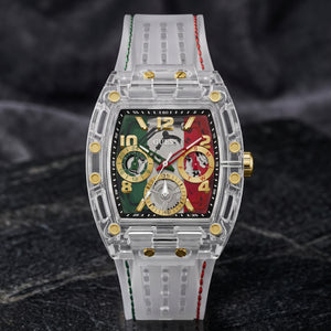 A luxury watch by Guess featuring a transparent acrylic case, a colorful dial with green, red, and gold sections, and a white silicone strap with green and red stitching, set against a dark textured background.