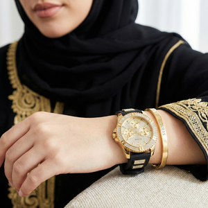 AI lifestyle shot of a woman wearing Guess W1160L1 black and gold watch