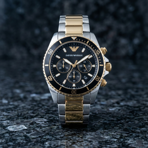Luxury Emporio Armani watch with black dial and gold accents on a dark textured surface
Close-up of AR11680 black dial showing solar technology and gold indices
