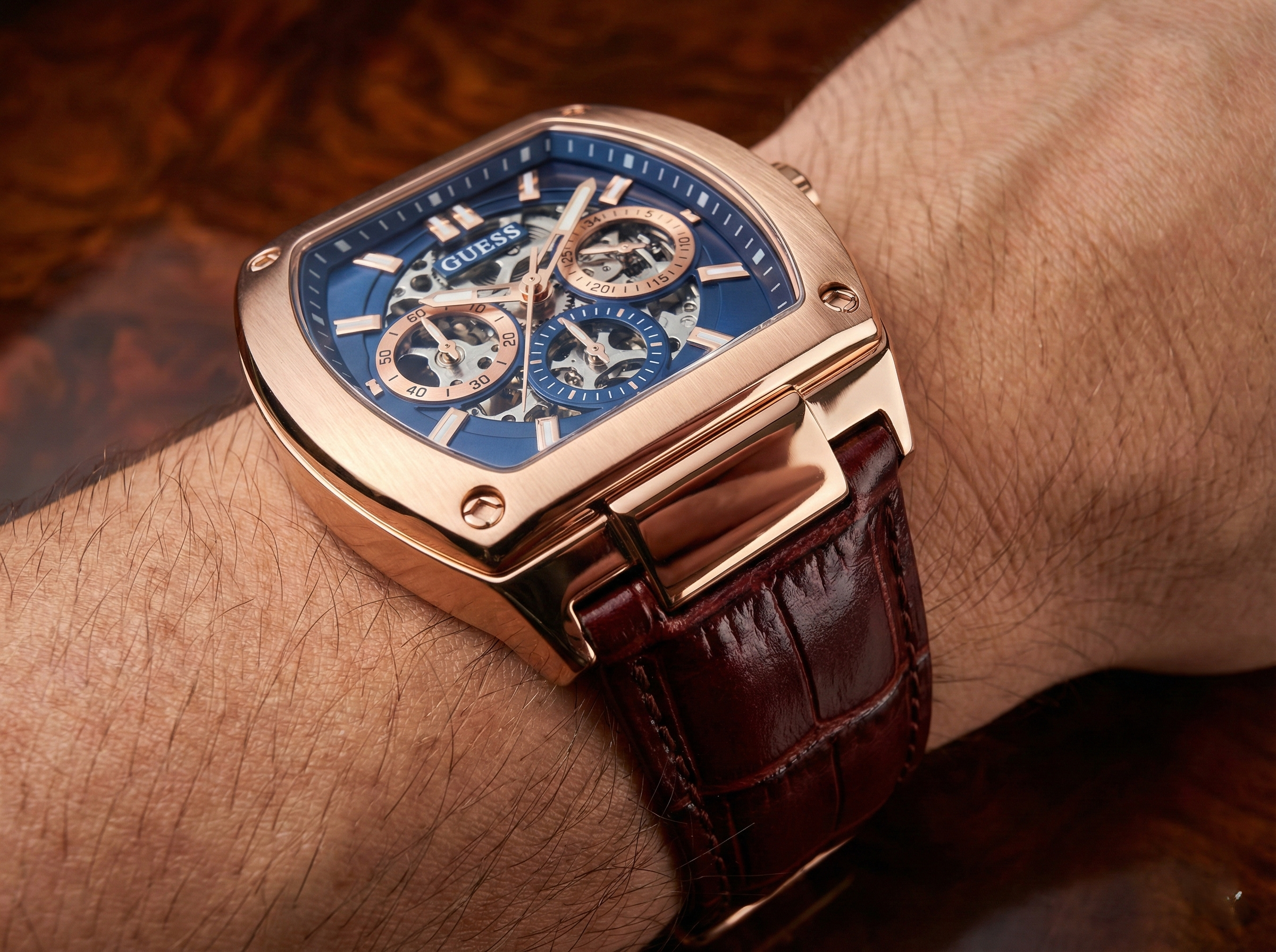 Close-up of Guess Phoenix GW0202G2 showing the blue dial with skeleton gear details