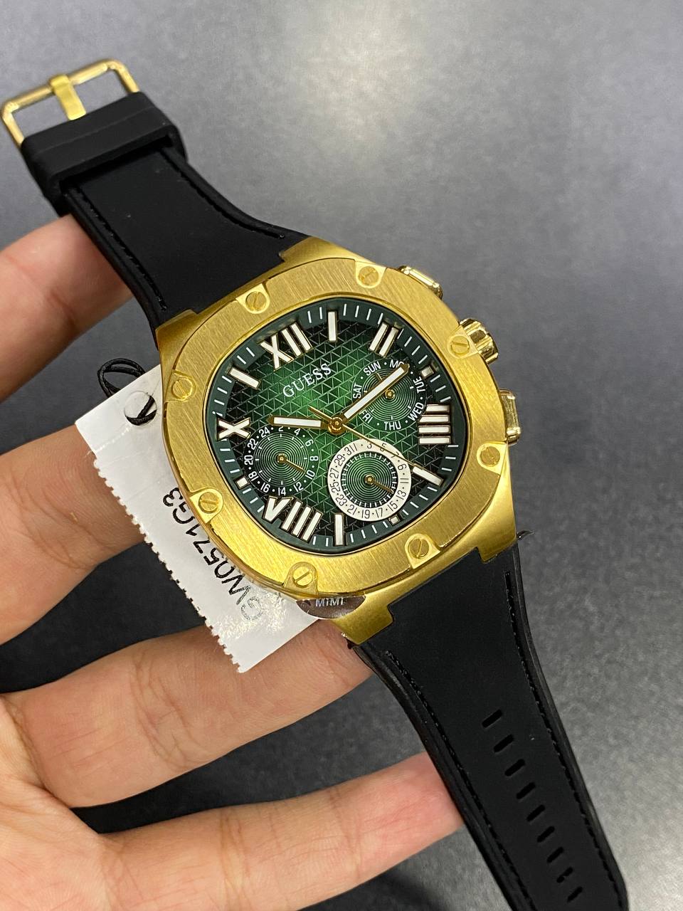 Authentic real-life photo of the Guess GW0571G3 showing actual gold luster and green dial color in Egypt