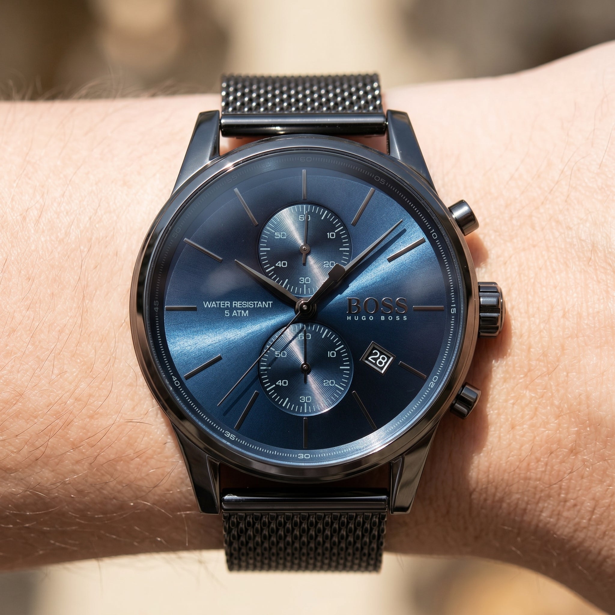 Close up shot of Boss Jet 1513677 on wrist showing the polished silver case and black tachymeter bezel from Luxury Hub Store