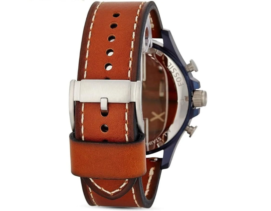 A close-up of a watch with a brown leather strap, silver-toned buckle, and a dark blue and silver-tone case, shown against a plain white background.