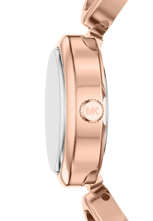 Close-up side view of a Michael Kors watch with a polished rose gold case and matching link band, featuring the brand's 'MK' logo on the side.