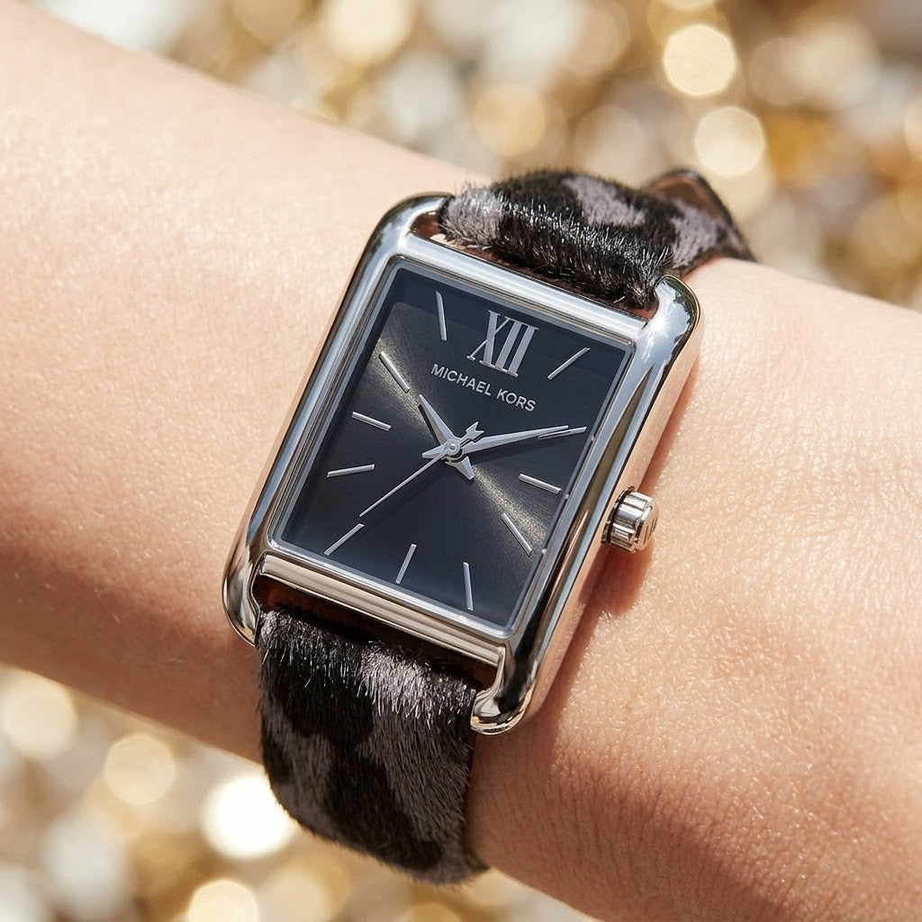Lifestyle photo of Michael Kors MKo1199 showing the elegant grey leopard print watch on a woman's wrist