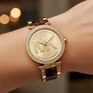 Extreme close-up of Michael Kors MK6109 showing tortoise acetate links and gold logo