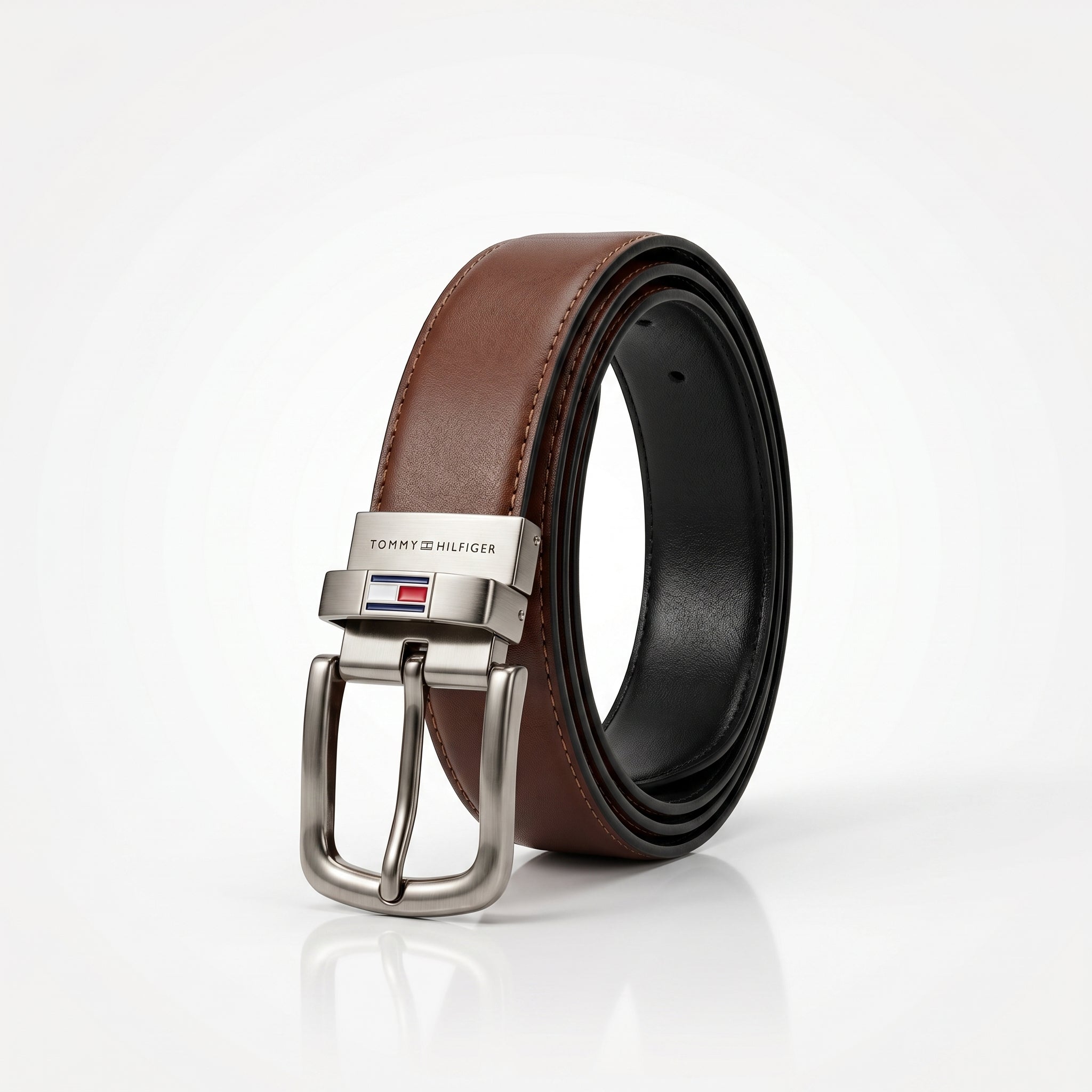 Brown leather belt with silver buckle on a white background