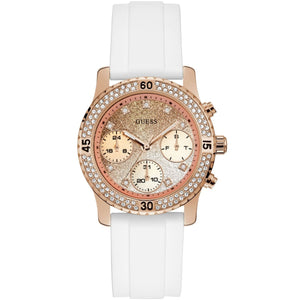 Guess Confetti Multi-Function W1098L5 women's watch with cushion-shaped rose gold-tone case, dynamic bezel embellished with crystals and screw details, deep silver-white dial with rose gold luminous hands and indices, and integrated flexible pure white silicone rubber strap main view