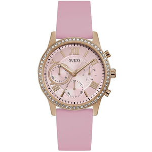 Guess Solar W1135L2 women's quartz battery multi-function watch with cushion-shaped gold-tone case, dynamic bezel embellished with crystals and screw details, deep silver-white dial with yellow gold luminous indices, and integrated flexible light pink silicone rubber strap main view