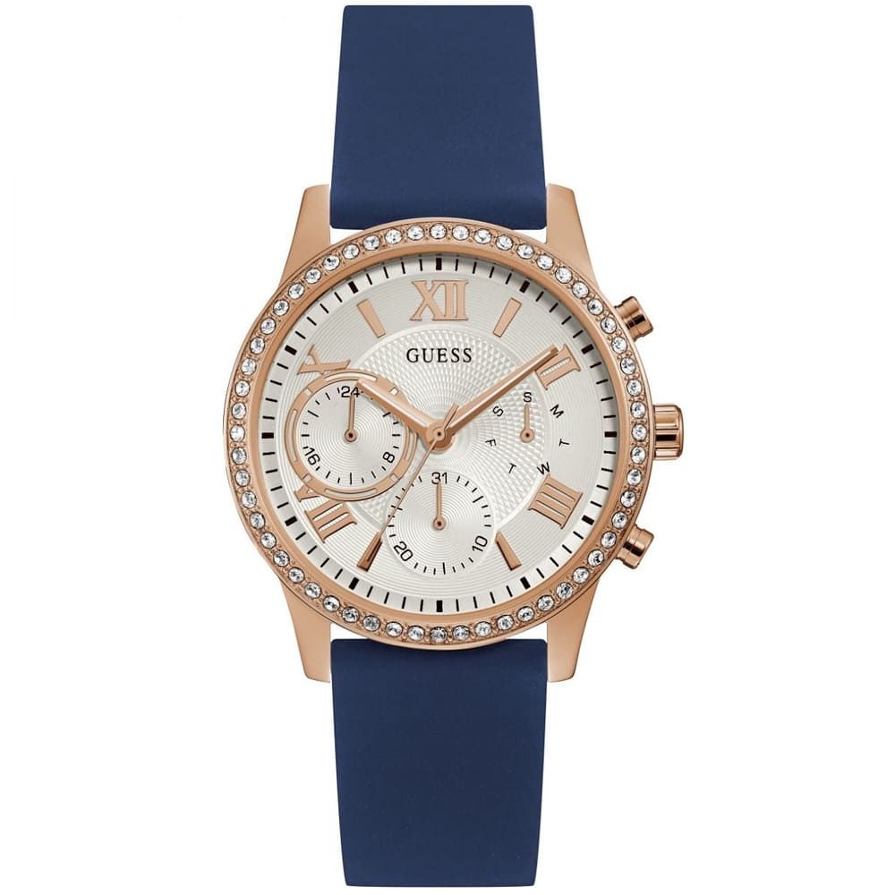 Guess Solar W1135L3 women's quartz battery multi-function watch with cushion-shaped gold-tone case, dynamic bezel embellished with crystals and screw details, deep silver-white dial with luminous yellow gold indices, and integrated flexible royal blue silicone rubber strap main view