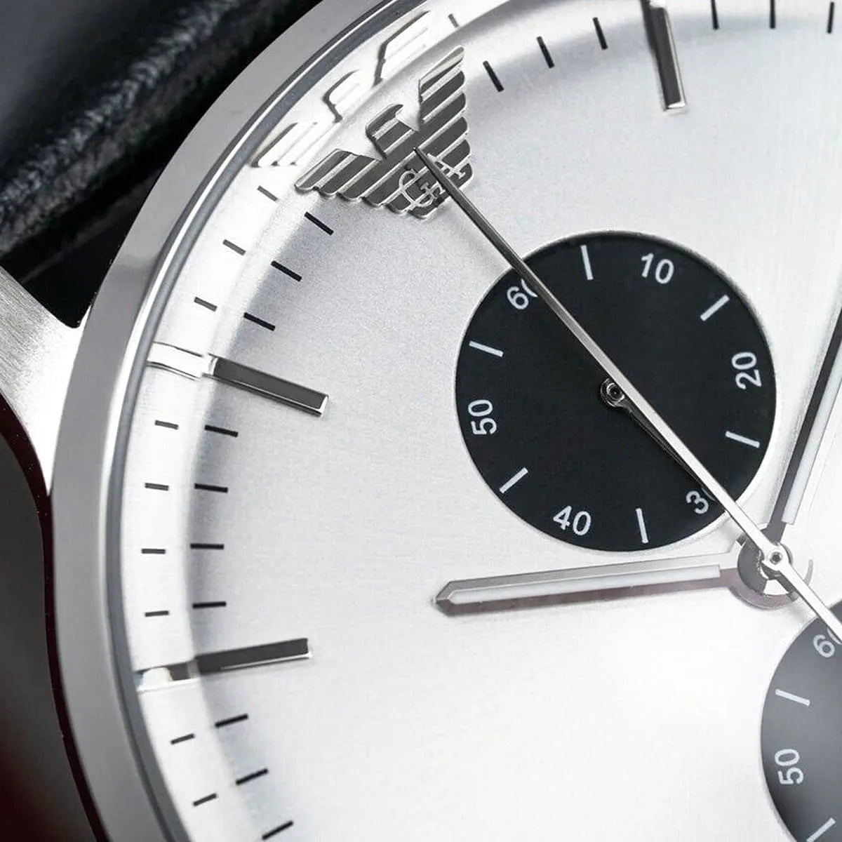 Close-up of Emporio Armani eagle logo and hands on AR0385 watch