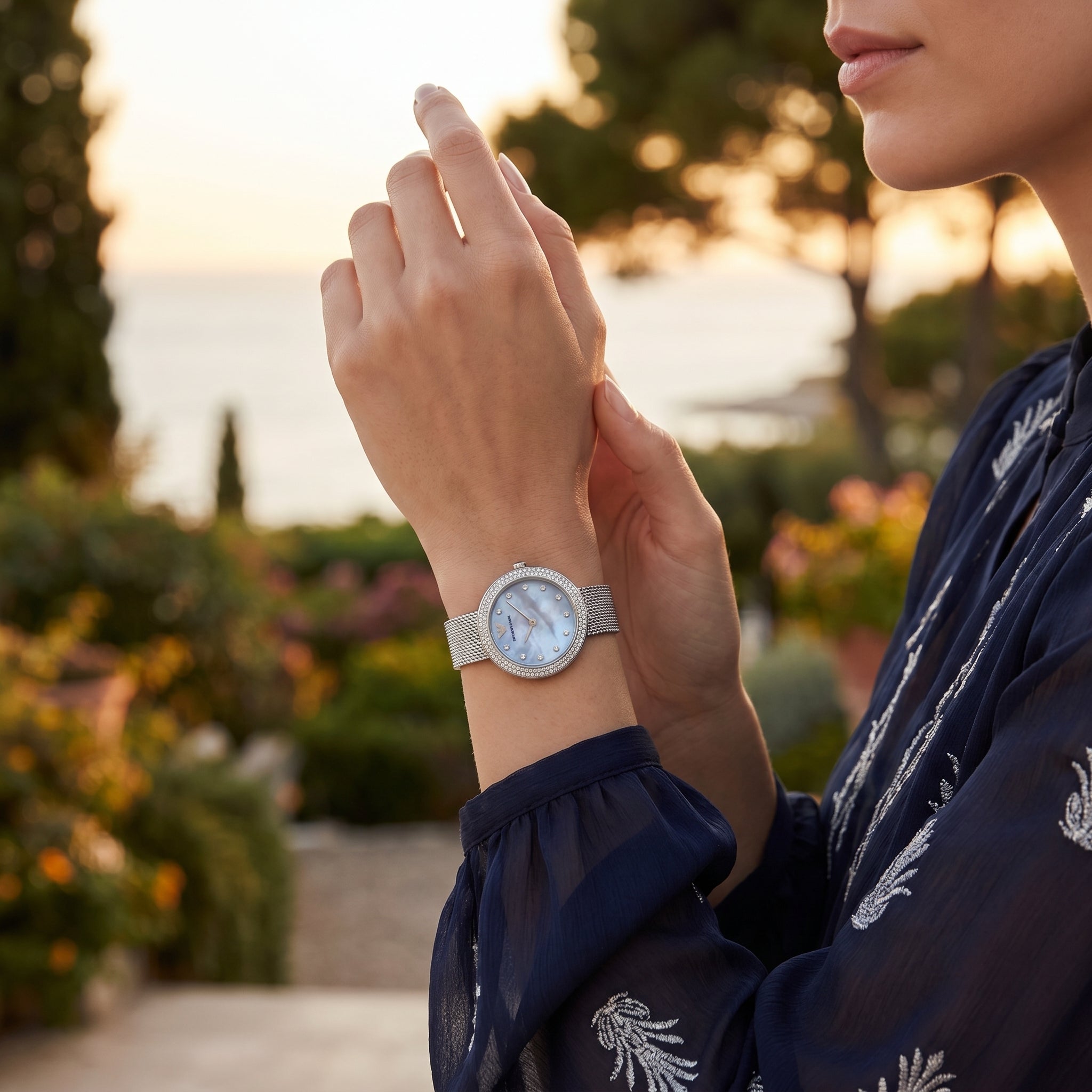 Female model wearing Emporio Armani Rosa silver mesh watch for an elegant luxury look