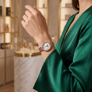 Female model wearing Emporio Armani Rosa rose gold moonphase watch for a sophisticated luxury look
