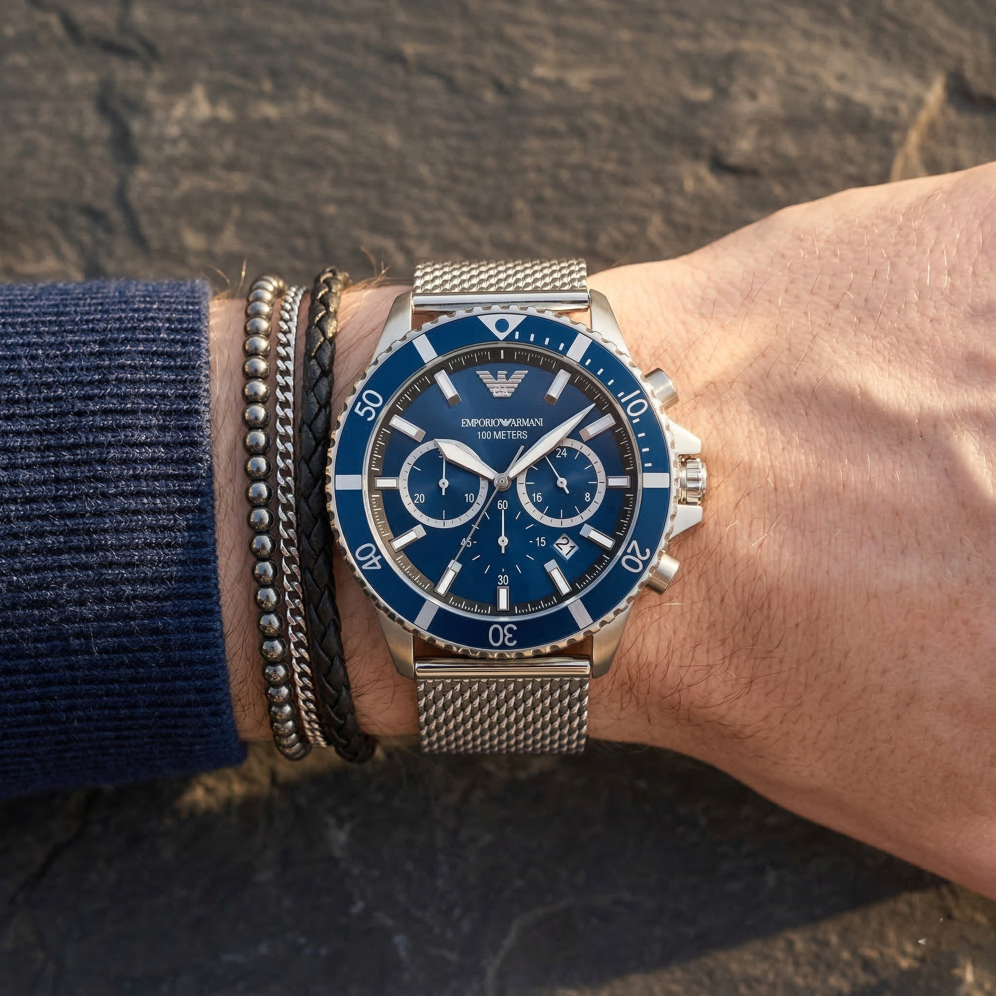 Close up of Emporio Armani Diver AR11587 men's quartz battery watch on wrist showing blue sunray dial and silver mesh bracelet