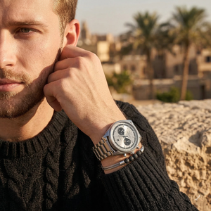 Elegant man wearing Emporio Armani Racer AR11636 men's quartz battery watch with silver-tone case and luxury metal bracelet