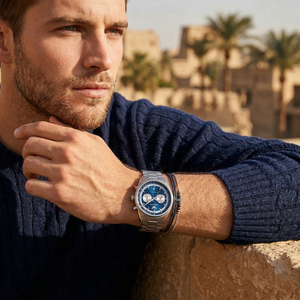 Elegant man wearing Emporio Armani Racer AR11676 men's quartz battery watch with silver-tone case and luxury metal bracelet