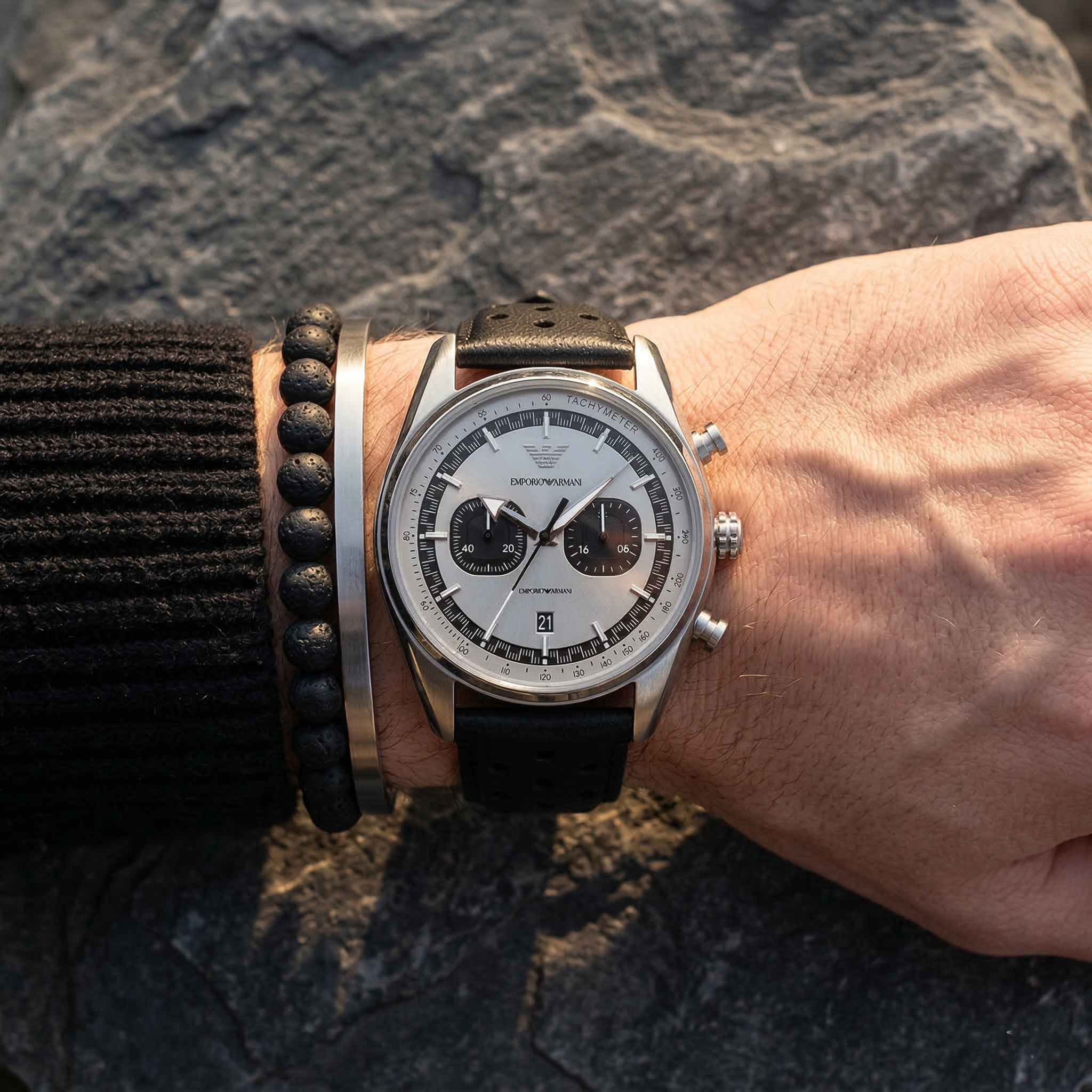 Close up of Emporio Armani Racer AR11677 men's quartz battery watch on wrist showing silver chronograph dial and racing leather strap